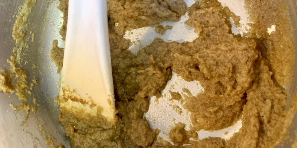Chicken curry paste is being mixed in a bowl.